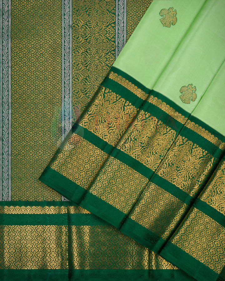 Elegant light green silk saree featuring gold floral zari and designer Kanchipuram pallu