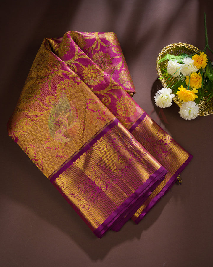 Folded magenta Kanjivaram silk saree with heavy gold zari pallu – festive and gifting silk saree