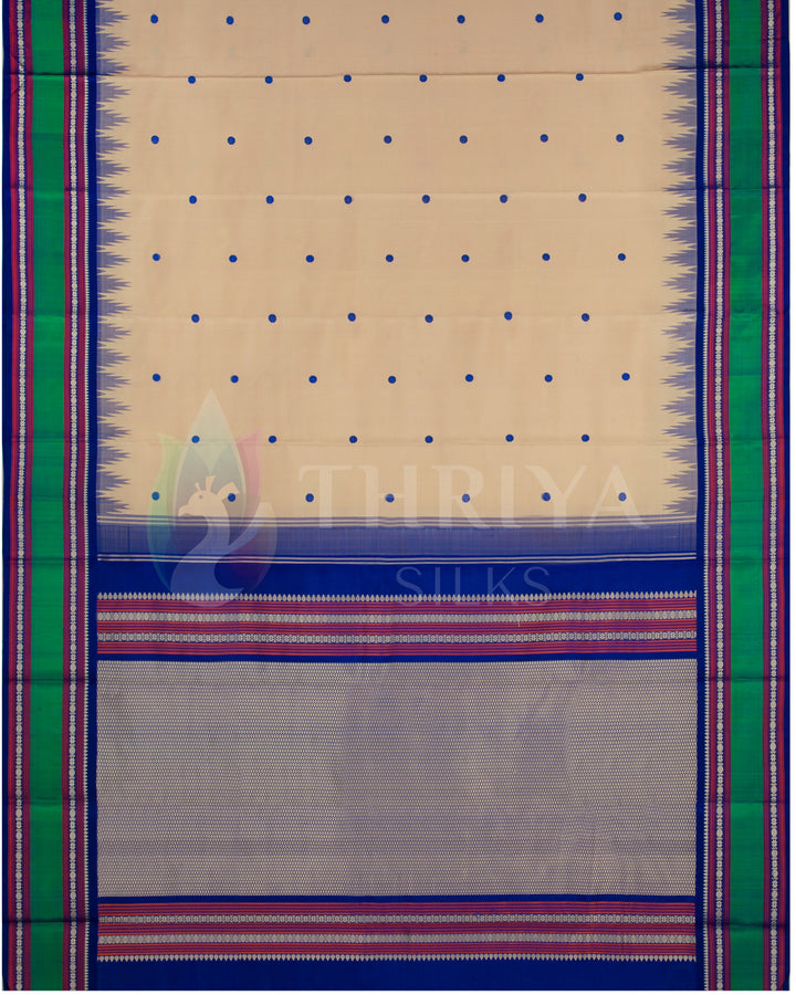 Full layout of beige silk saree with contrast green border and intricate blue pallu, Thriya Silks