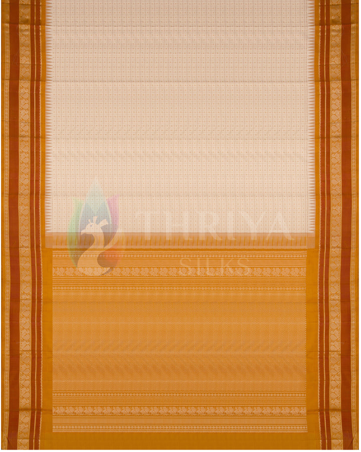 Full layout of cream silk saree with golden-orange pallu and rich zari woven border