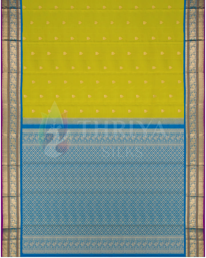 Full flat lay of lime yellow and blue silk saree with intricate gold zari work from Thriya Silks