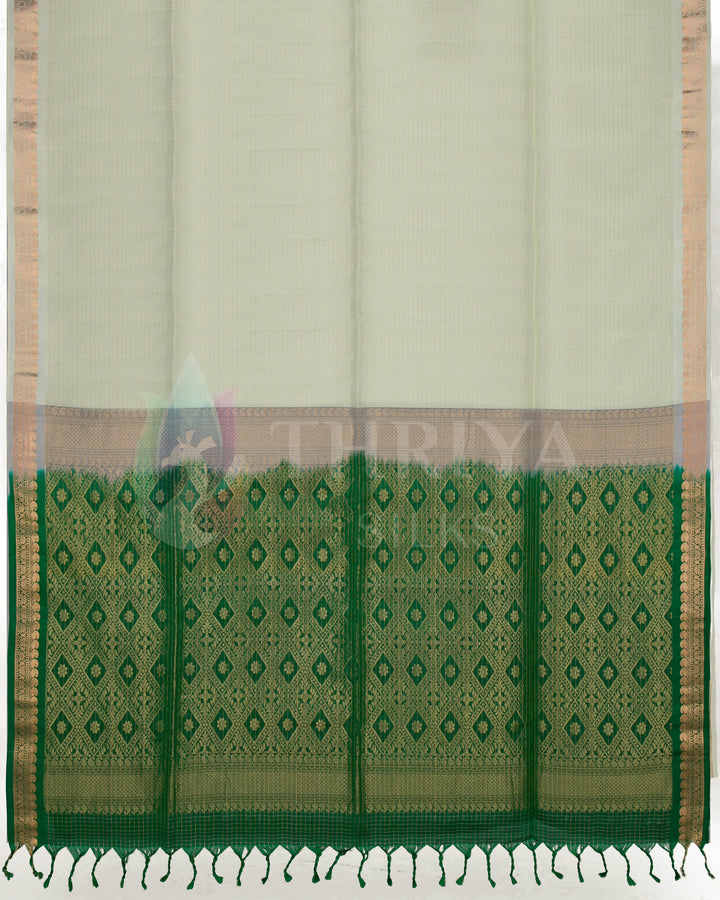Full view of off-white silk saree with vibrant green zari pallu and elegant gold motifs