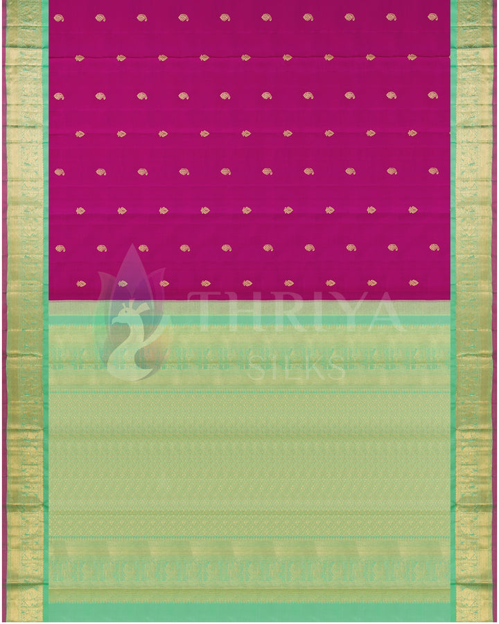 Full view of traditional silk saree with rani pink body, gold motifs, and light green zari pallu and border