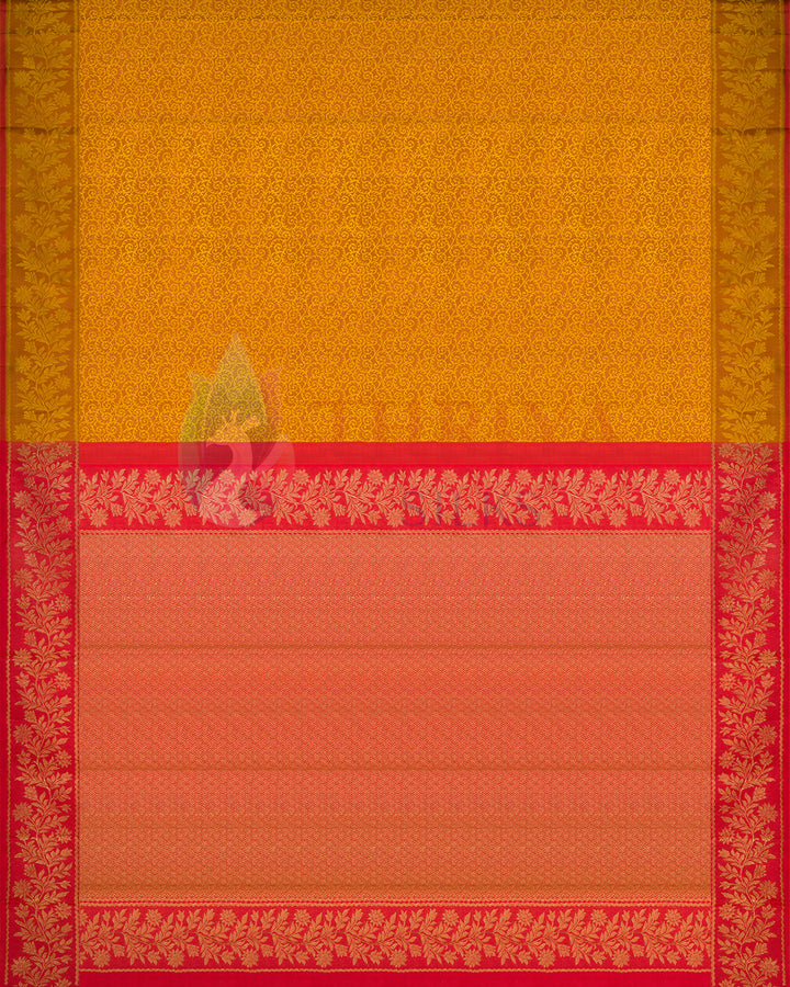 full view of yellow Kanjivaram silk saree featuring intricate golden floral weaves and contrasting red zari border – traditional bridal saree 