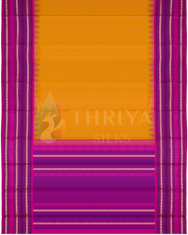 Full layout of yellow Kanjivaram silk saree featuring bold pink pallu and temple design