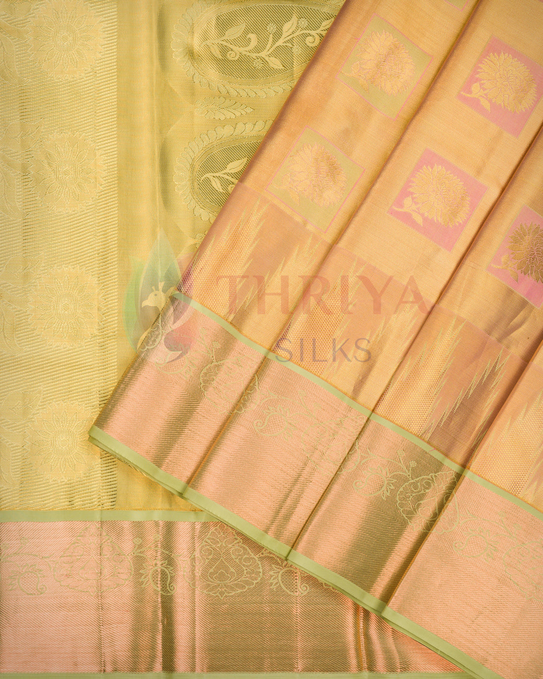 Traditional golden yellow Kanjivaram silk saree with green zari pallu displayed, showing exquisite craftsmanship.