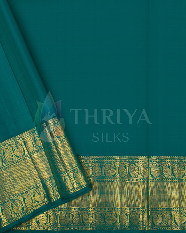 Plain green blouse piece with gold zari border complementing the mustard yellow cow motif silk saree.