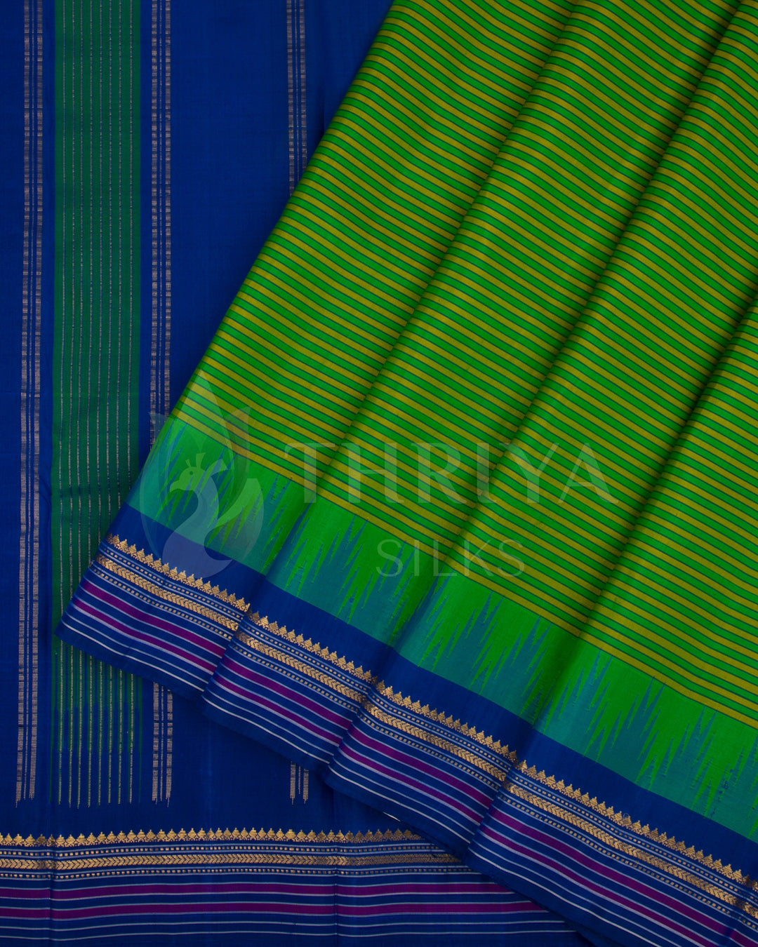 Green and blue silk saree showing pleats with intricate golden and pink border design, from Thriya Silks