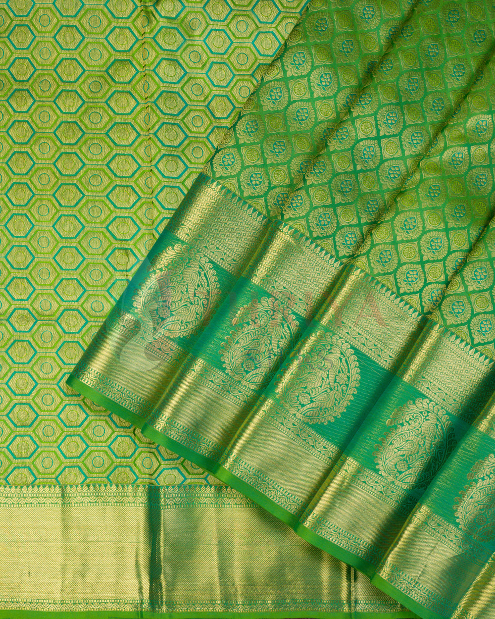 Green Kanjivaram silk saree with golden hexagonal zari weaving and rich traditional pallu