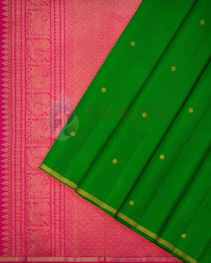 Kanchi silk saree in green with gold dot buttas and pink woven zari border and pallu