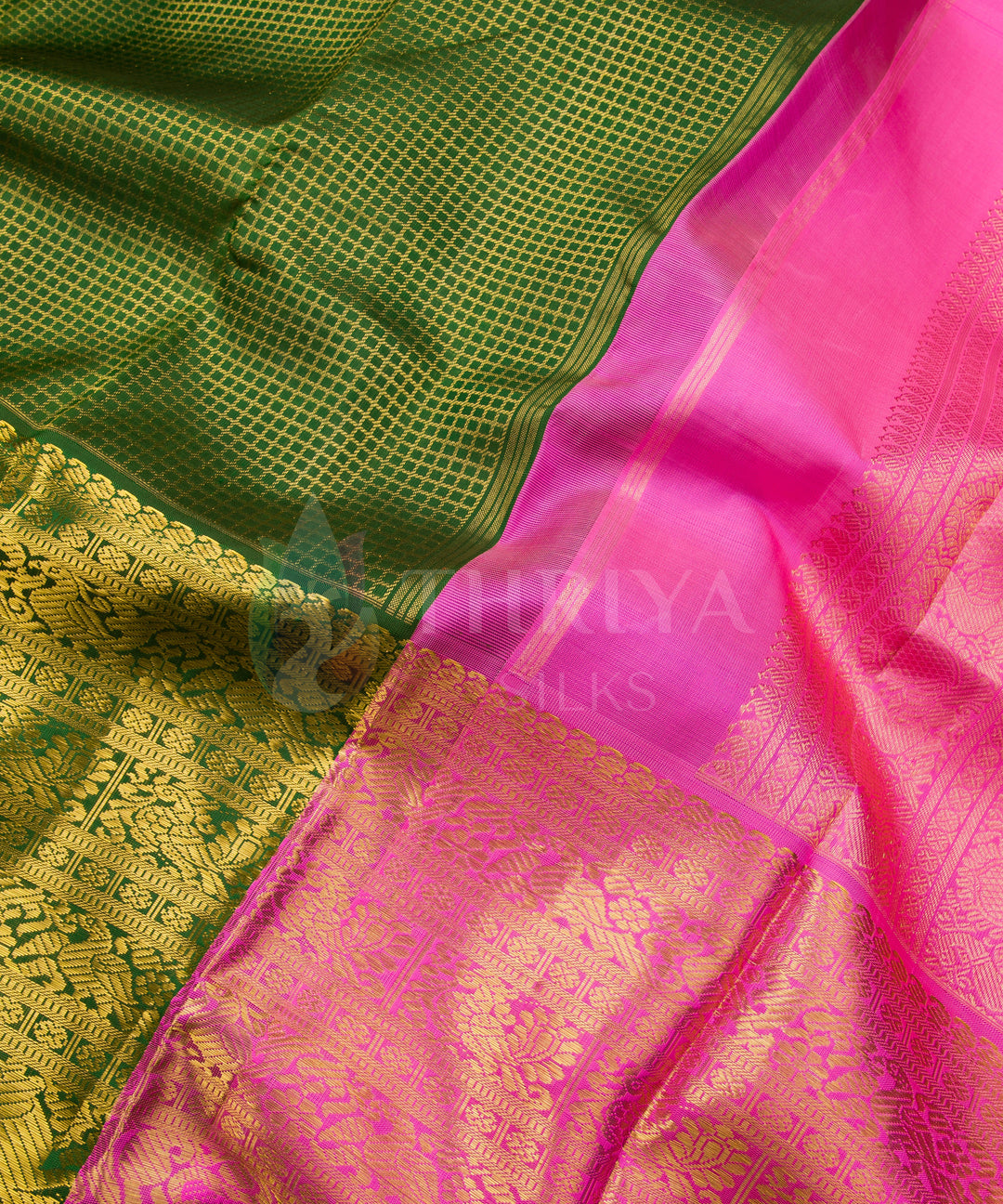 Rich green Kanchipuram silk saree with bright pink border and shimmering gold zari detailing