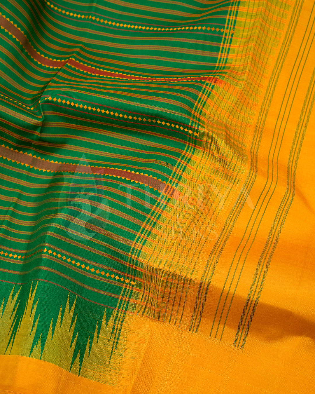 Close-up of green and yellow silk saree pallu with detailed traditional woven designs, Thriya Silks