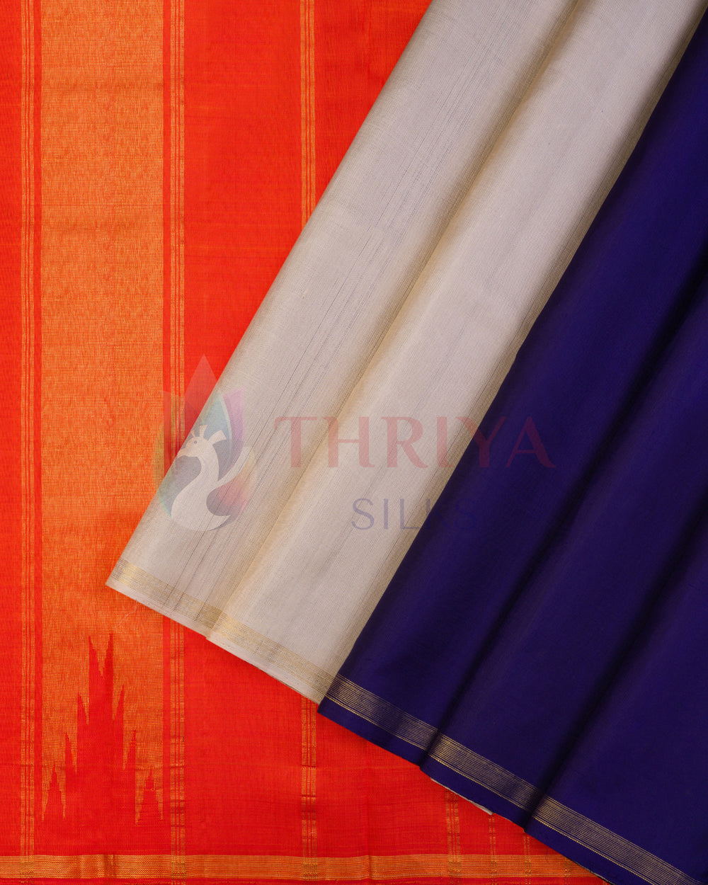 Half and half Kanchipuram silk saree in vibrant orange, royal blue, and white with traditional zari border