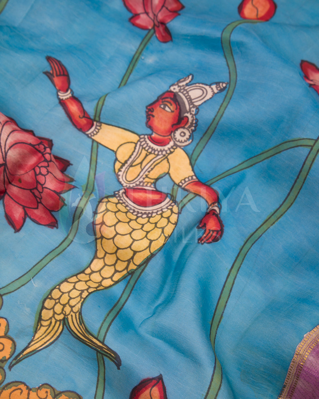 Detailed view of mermaid Kalamkari hand-painting on vibrant blue silk saree