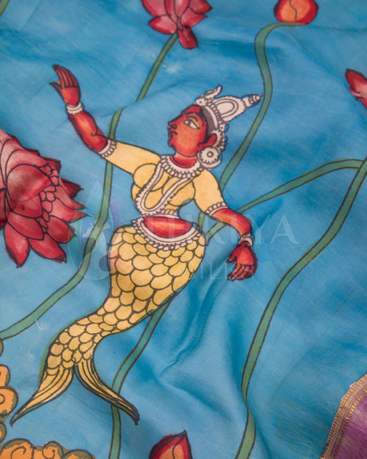 Detailed view of mermaid Kalamkari hand-painting on vibrant blue silk saree