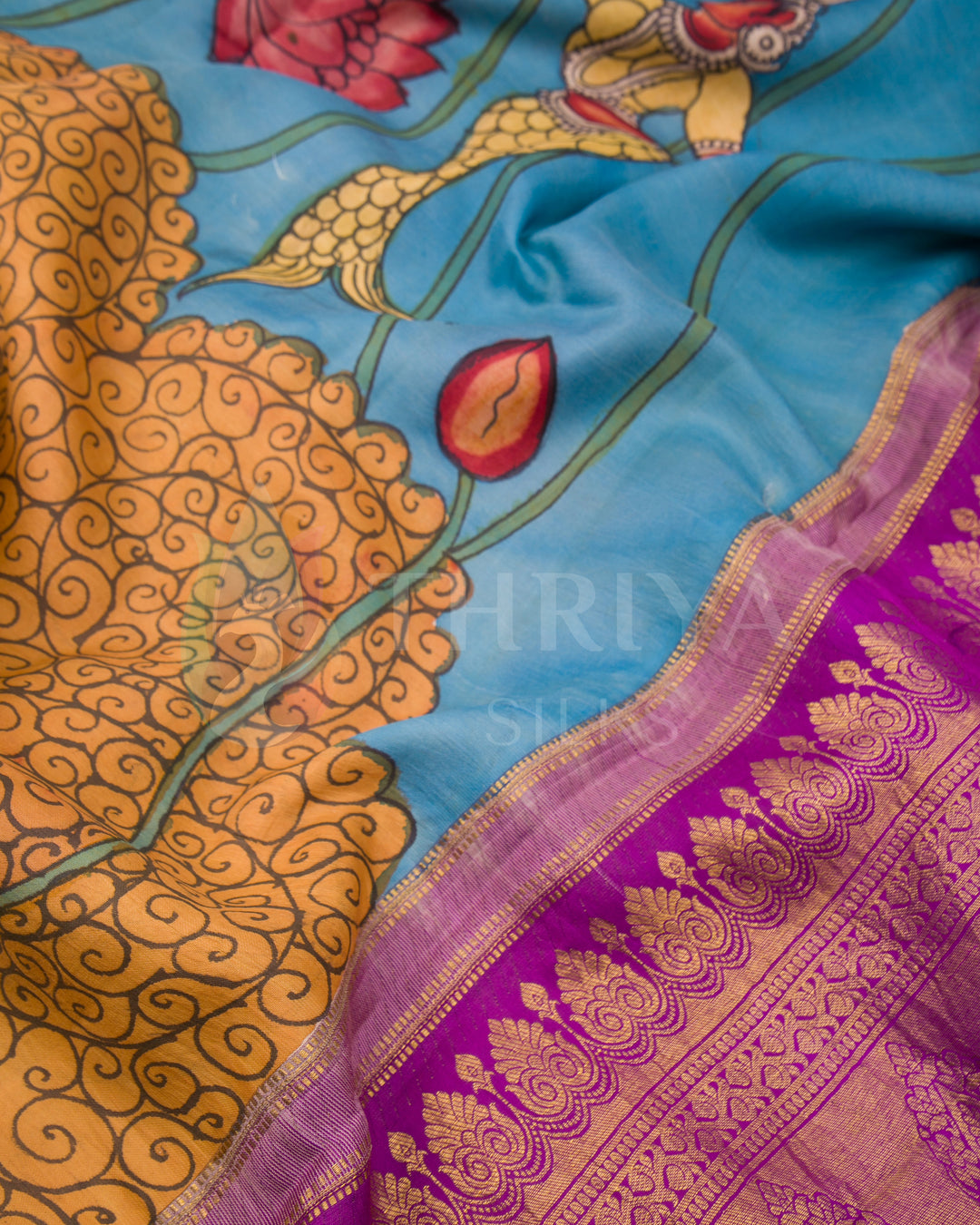 Close-up of lotus vines and floral Kalamkari artwork with rich purple zari border
