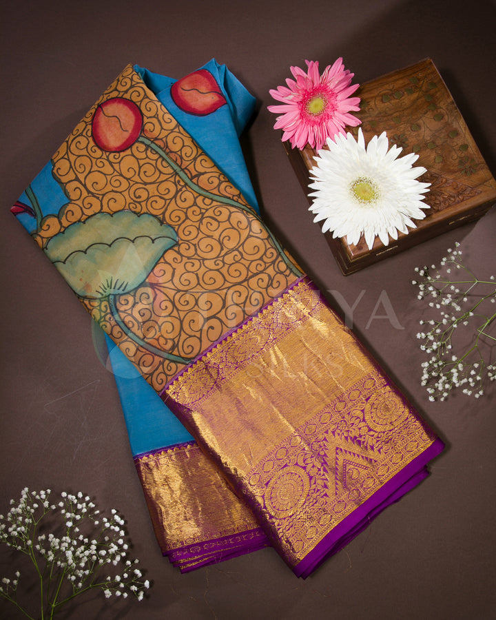 Folded view of blue Kalamkari silk saree with mermaid and lotus motifs and purple zari border