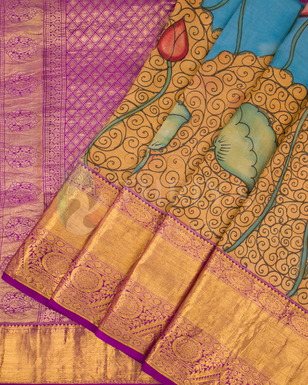 Close-up of pleats showing mermaid Kalamkari artwork and intricate golden zari border