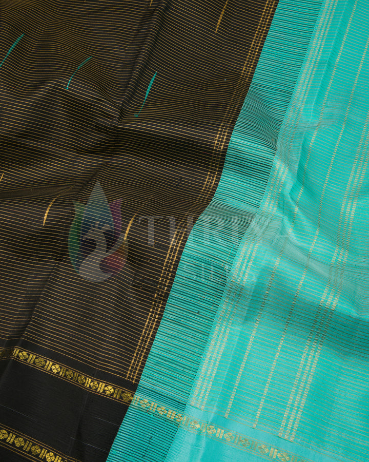Close view of pallu and body weave pattern of black silk saree with turquoise pallu and zari by Thriya