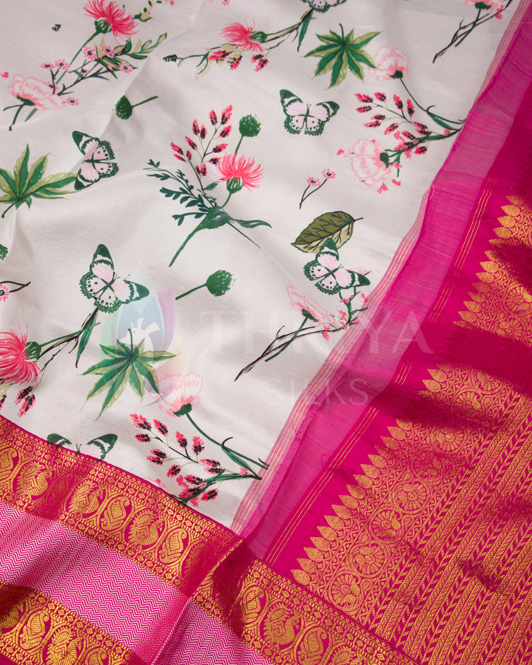 Detailed view of Kanchipuram silk saree showing floral printed body and richly woven pink zari pallu.