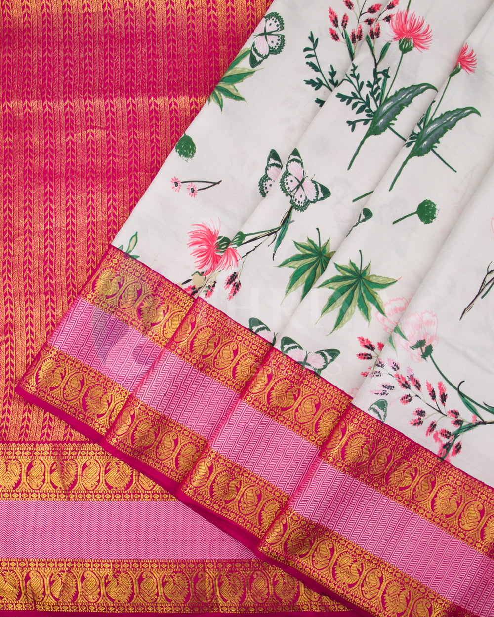 Close-up highlighting the floral print with butterflies and the gold zari border on the Kanchipuram silk saree, showcasing fine craftsmanship