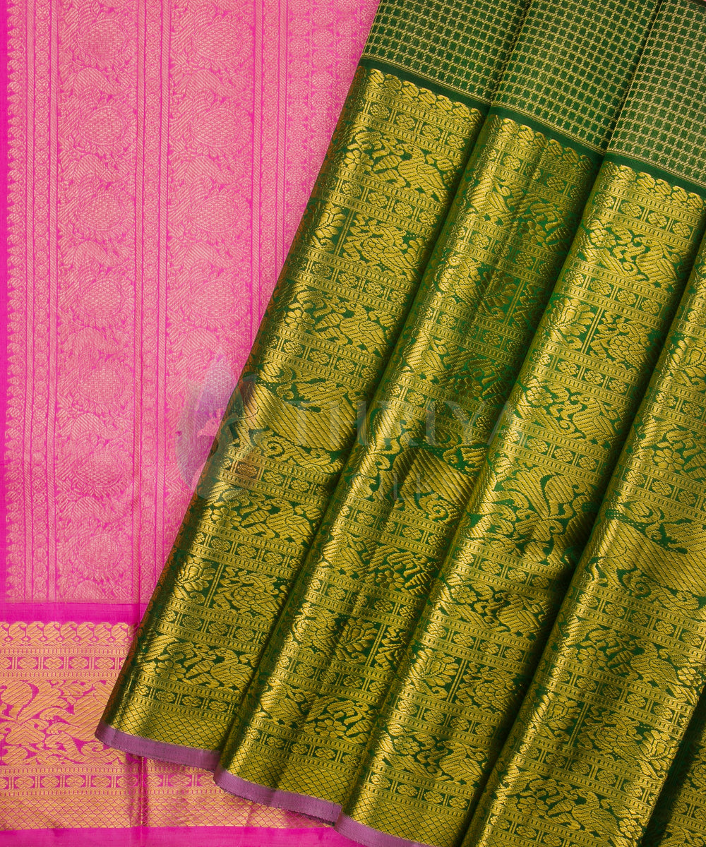 Traditional Kanchipuram silk saree showcasing gold zari pleats with green body and pink pallu.