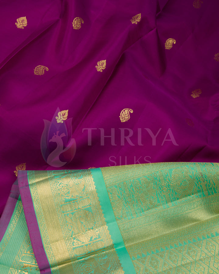 Detailed angle showing pleats and pallu of purple silk saree with contrasting green zari border