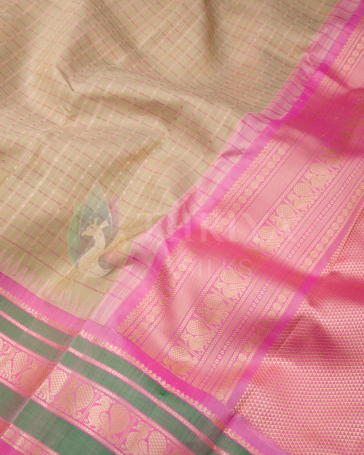 Beige silk Kanjivaram saree with pink pallu and gold zari green border detail"