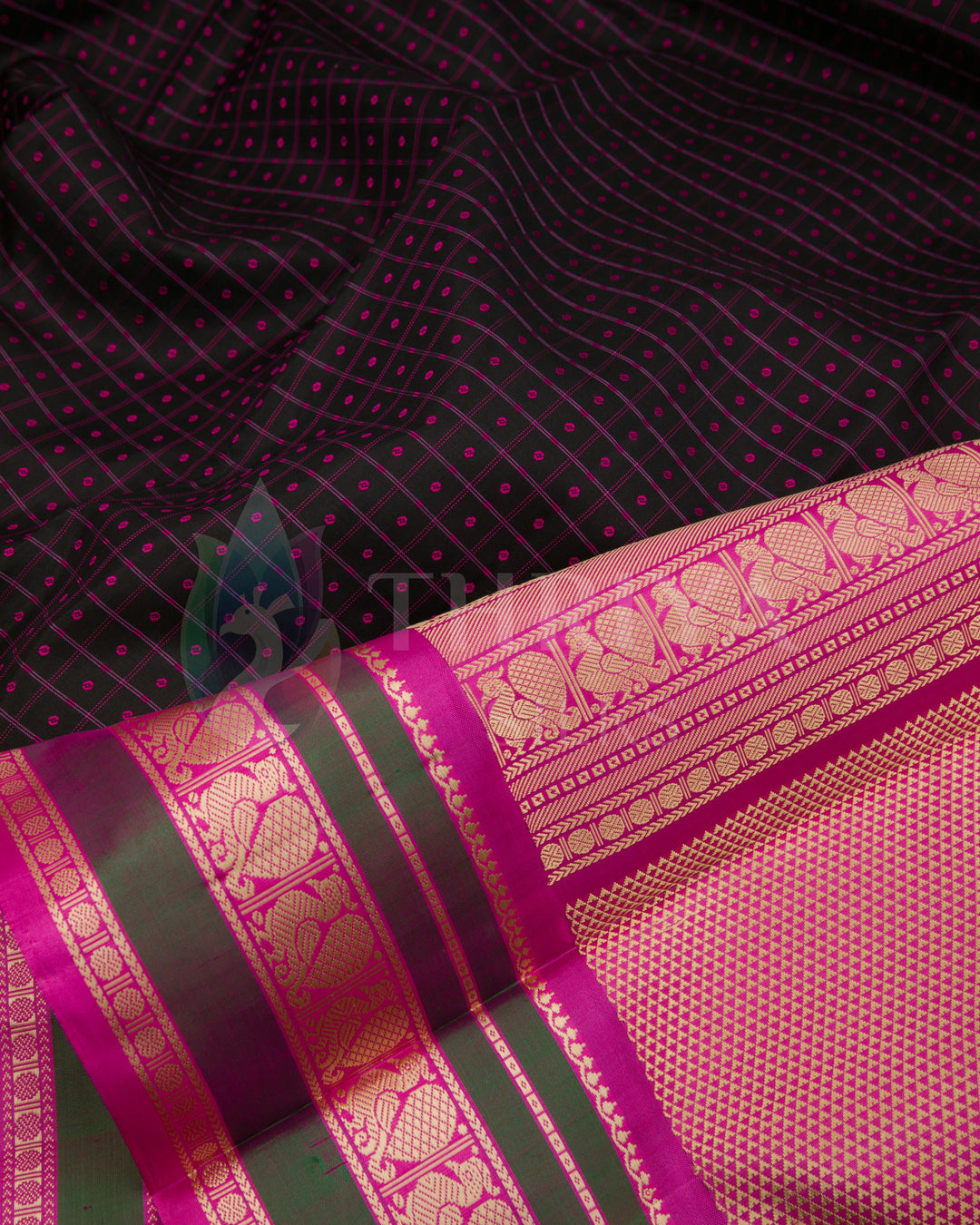 Detailed shot of black Kanjivaram saree body with pink threadwork and gold zari border