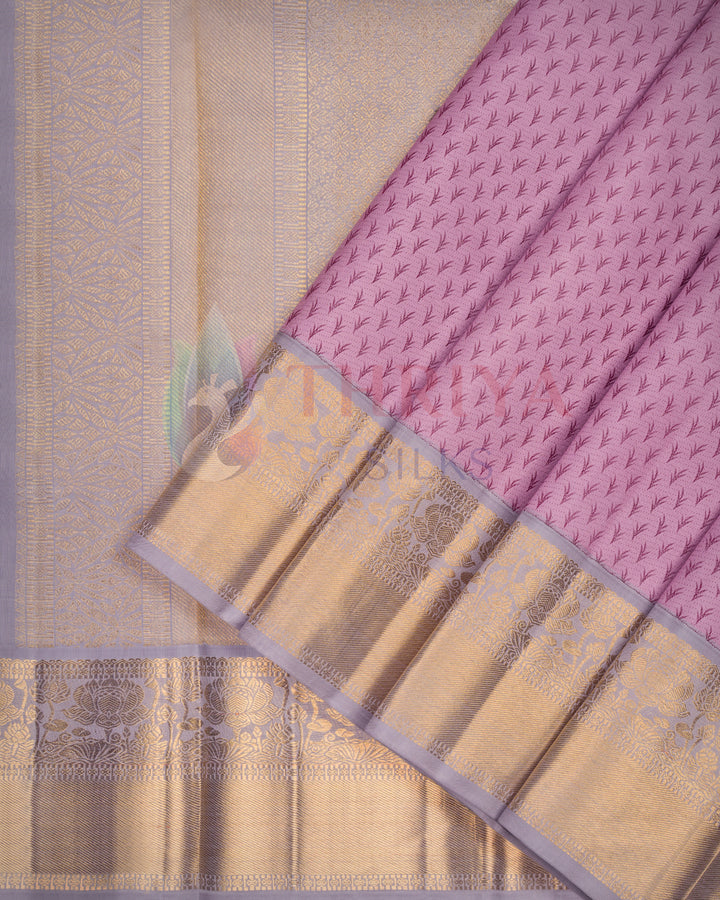 Elegant lavender Kanjivaram silk saree with intricate gold zari border and floral motifs – perfect for weddings and festivals