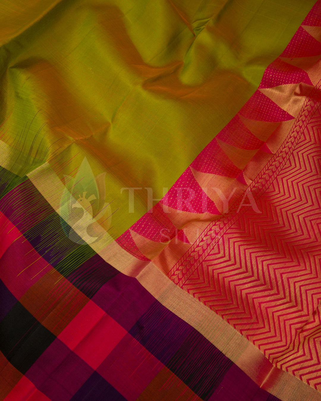  Close-up of lime green silk saree with detailed pink zari pallu and contrasting color checks