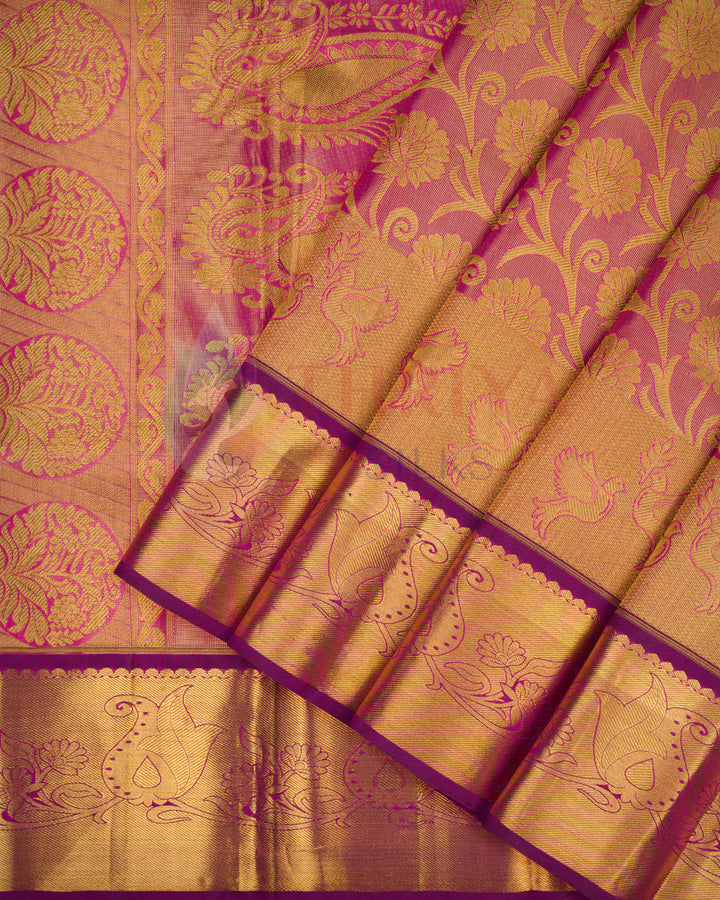 Magenta pink Kanjivaram silk saree with rich gold floral zari pleats and traditional border