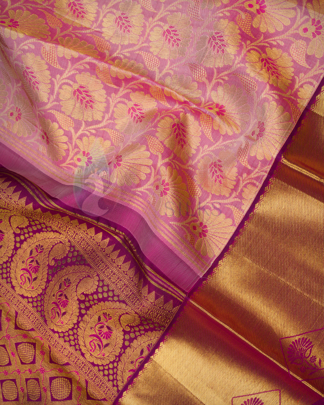 close-up of magenta Kanjivaram silk saree with intricate gold zari floral weaving