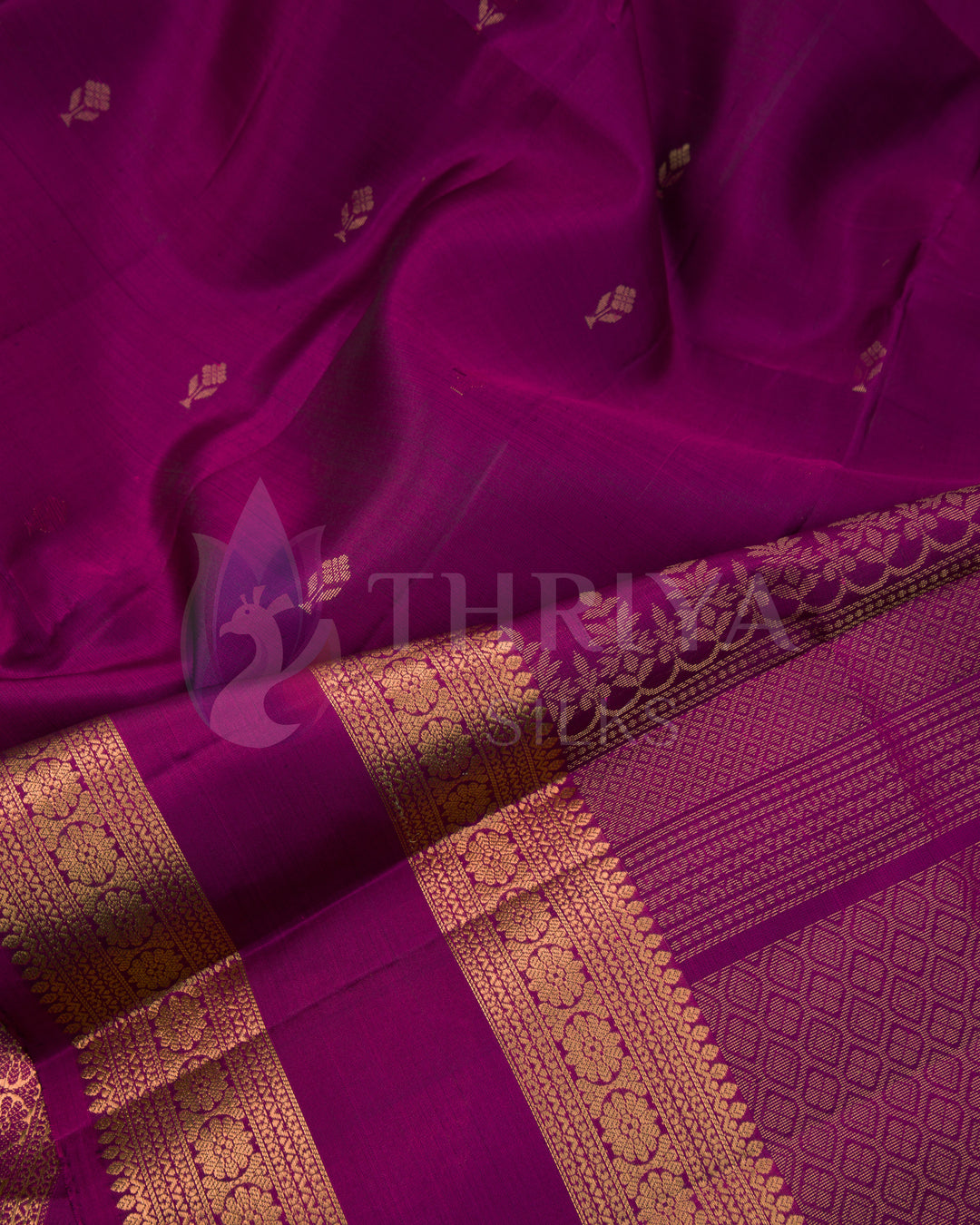 Close-up of magenta silk saree with shimmering gold zari detailing and small motifs
