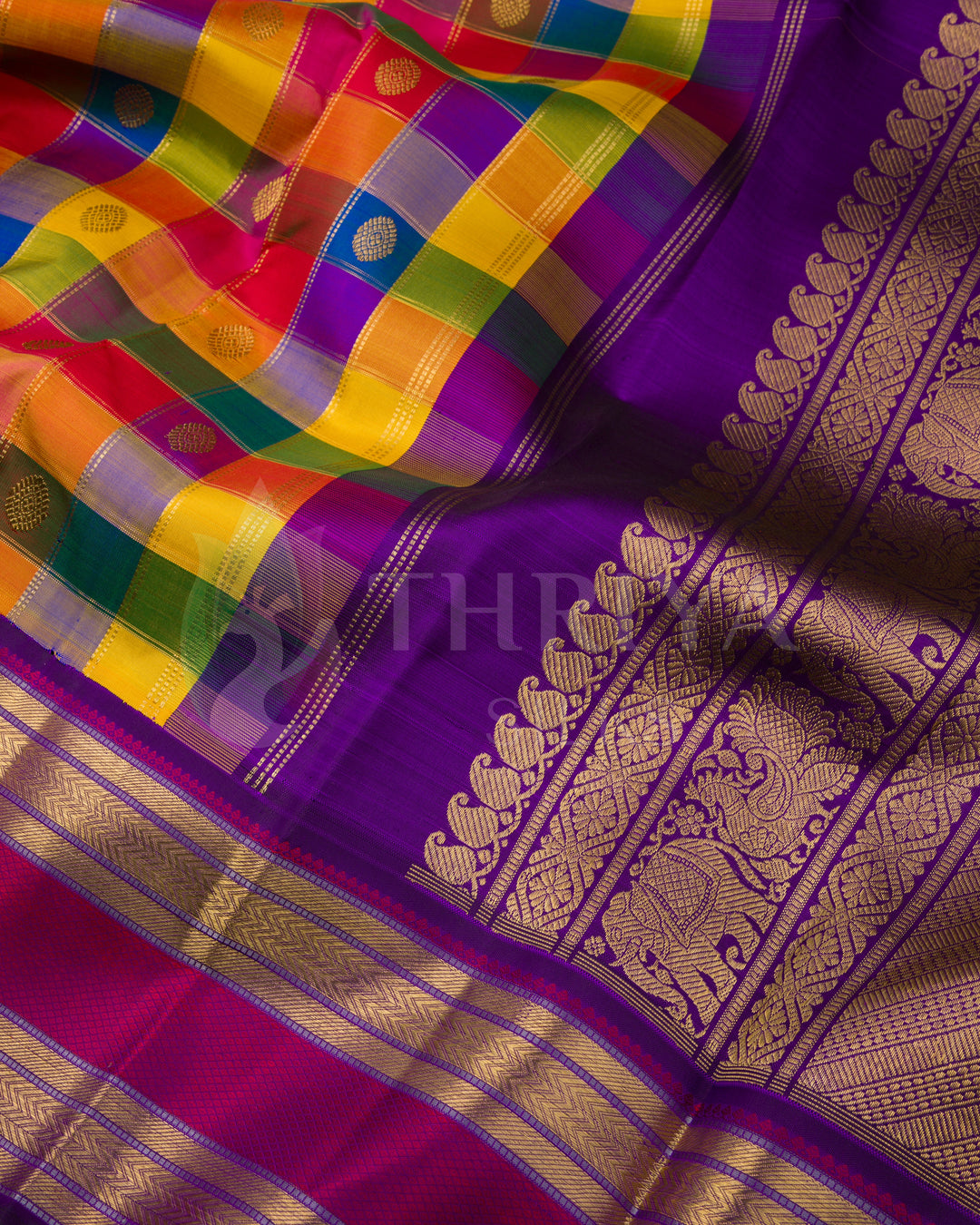 Close-up view of vibrant multicolor checked Kanchipuram silk saree with purple pallu and intricate golden zari detailing