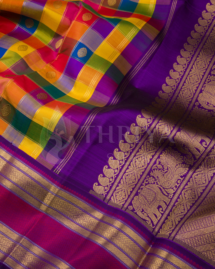 Close-up view of vibrant multicolor checked Kanchipuram silk saree with purple pallu and intricate golden zari detailing
