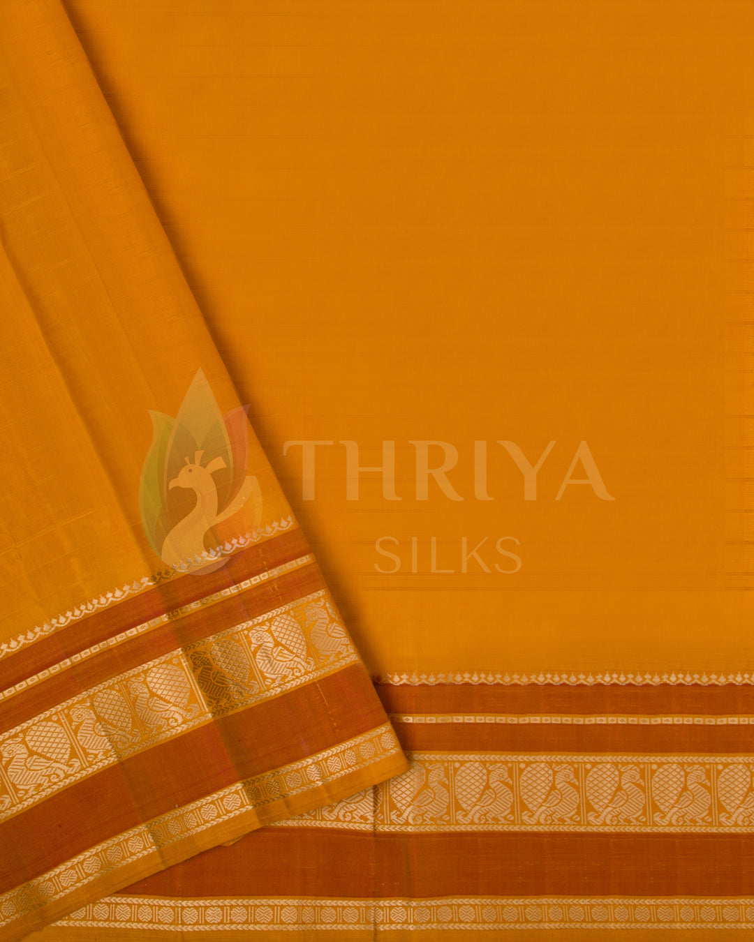 Mustard yellow blouse piece with traditional gold zari border paired with red saree from Thriya Silks