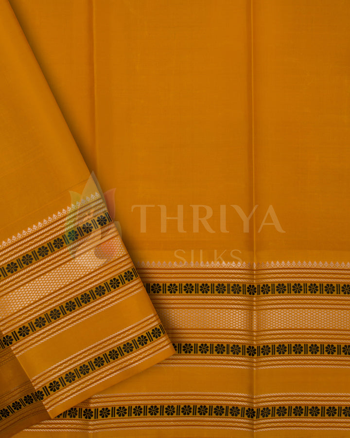 Mustard yellow Kanjivaram blouse piece with elegant woven zari and floral border