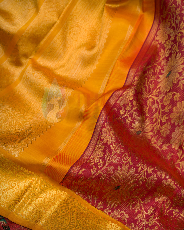 Close-up angle of mustard yellow Kanchipuram silk saree folded to highlight the golden zari border and smooth texture