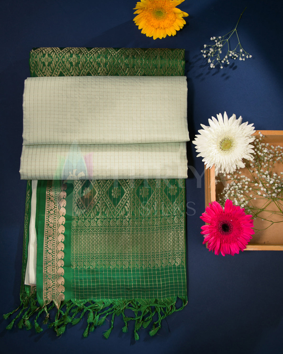 Off-white and green silk saree styled with floral decor in a lifestyle setting