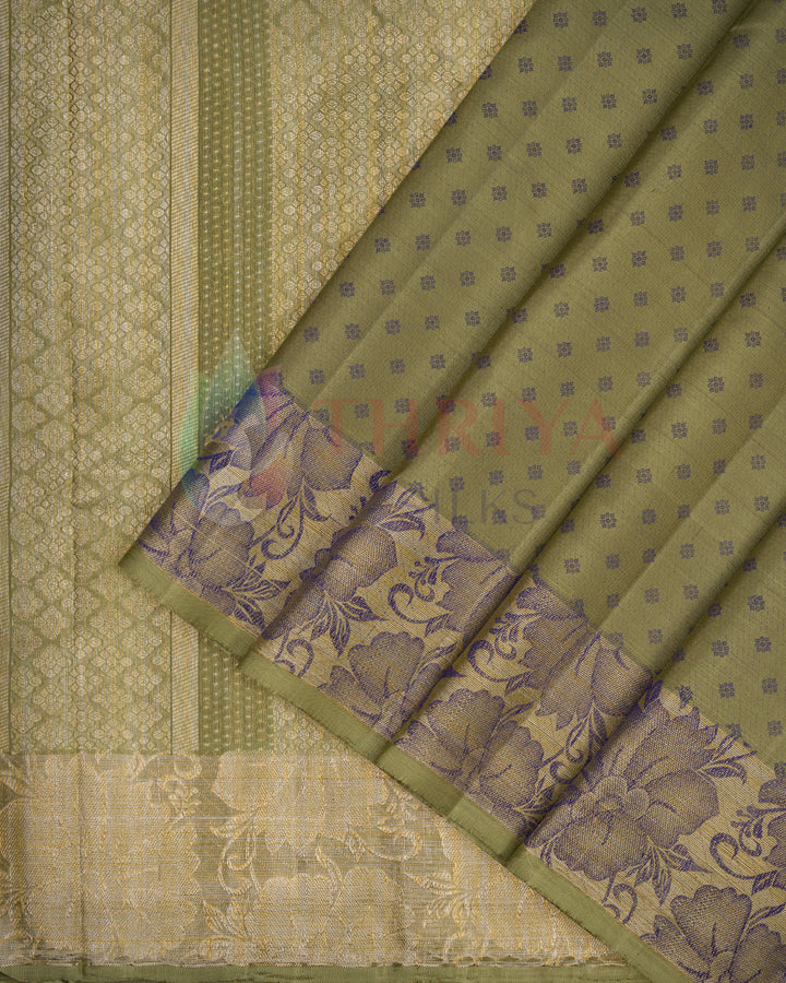 Close-up of olive green Kanchipuram silk saree showing purple zari floral border detail