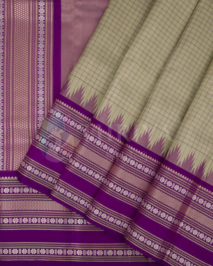 Olive green Kanjivaram silk saree with purple border and silver zari temple pallu