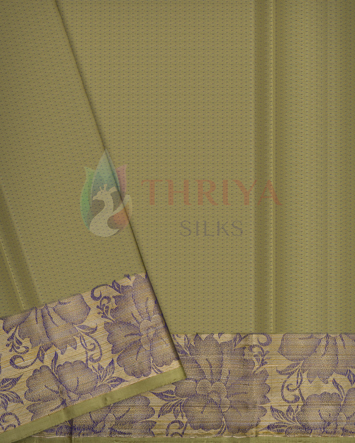 Close-up of olive green silk saree pallu with purple floral zari border