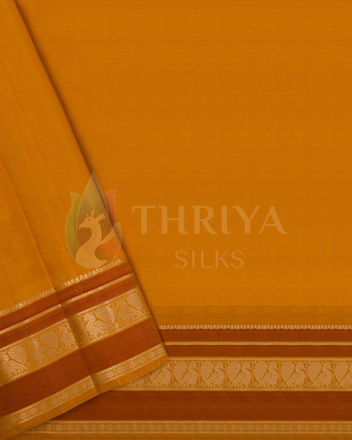 Unstitched orange blouse piece with gold zari border to match cream silk saree