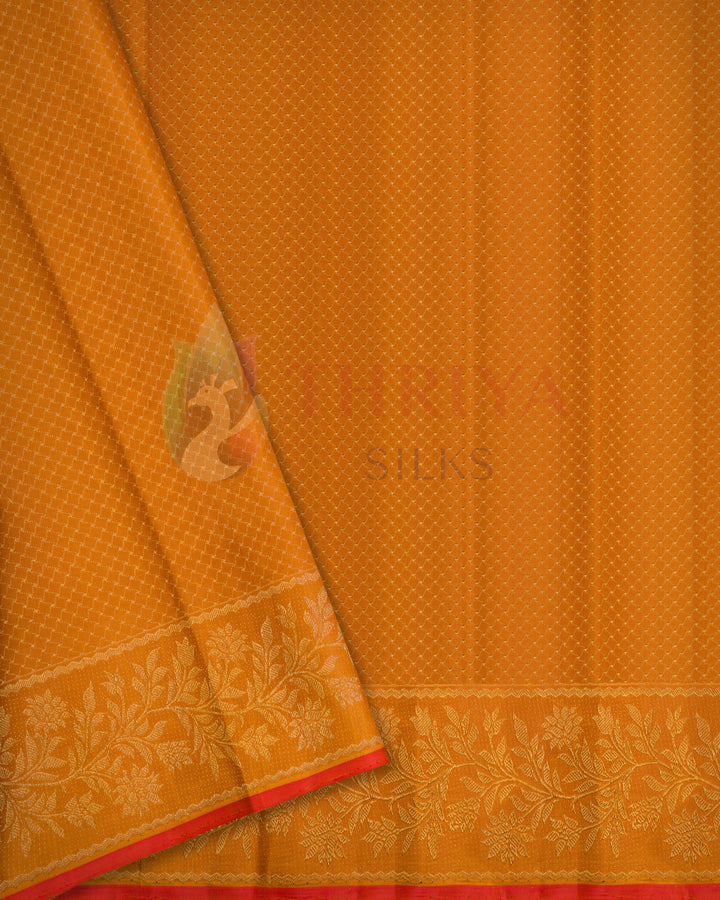 Orange Kanjivaram silk saree with delicate dotted pattern and rich golden zari floral border