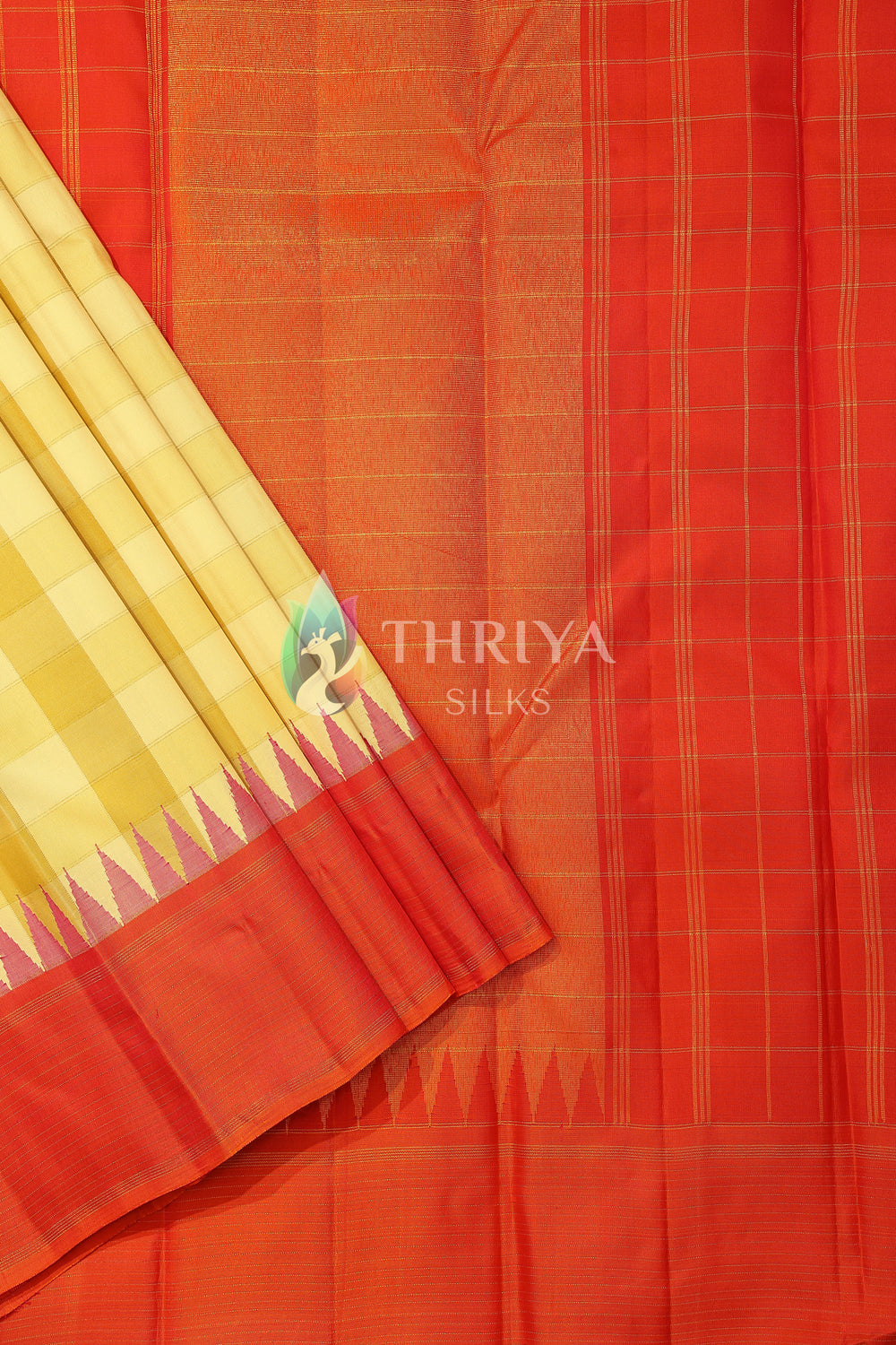 Orange silk saree featuring zari-checked pallu and contrasting yellow border.