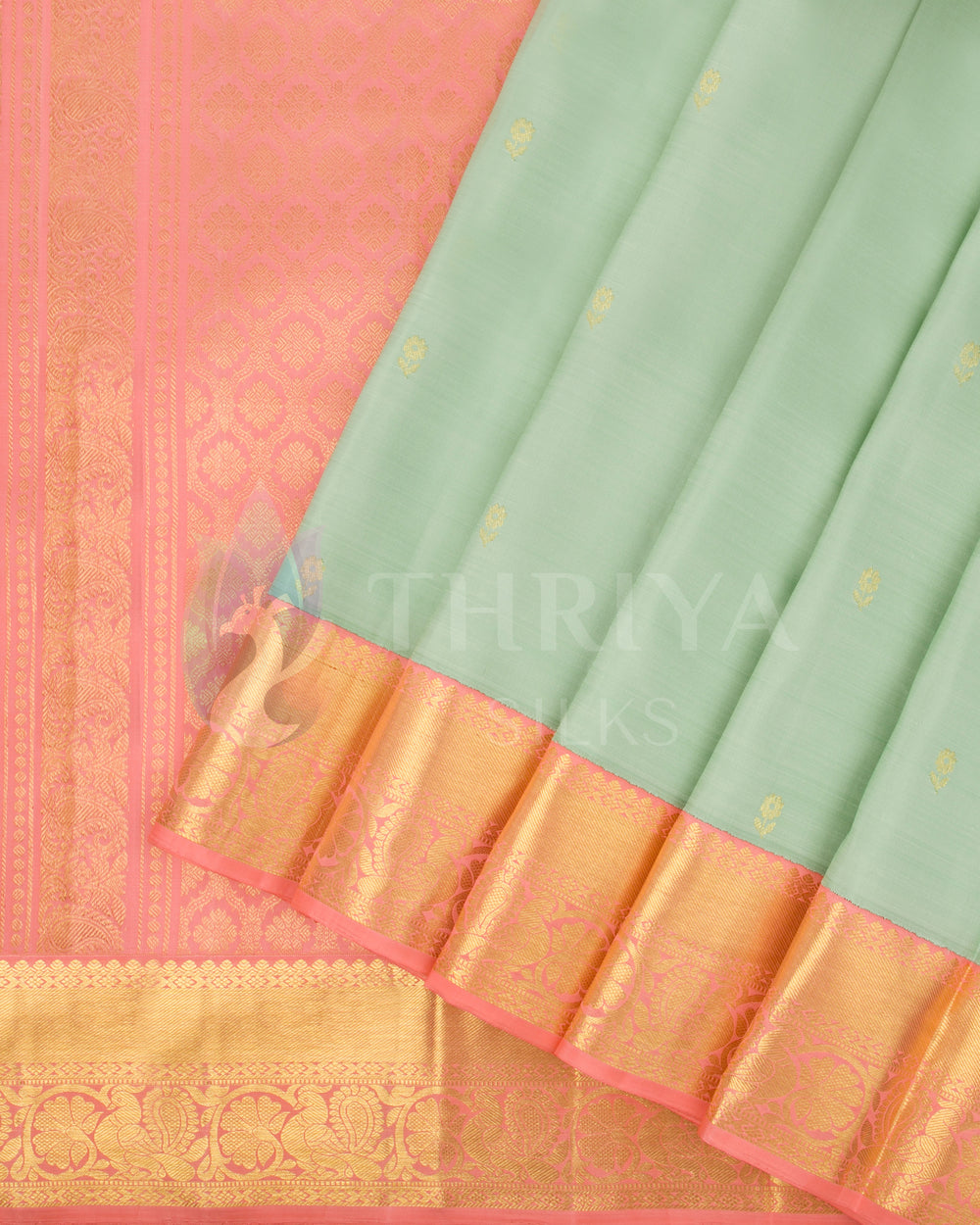 Pleats view of pastel green silk saree with gold motifs and peach-pink border in gold zari weaving