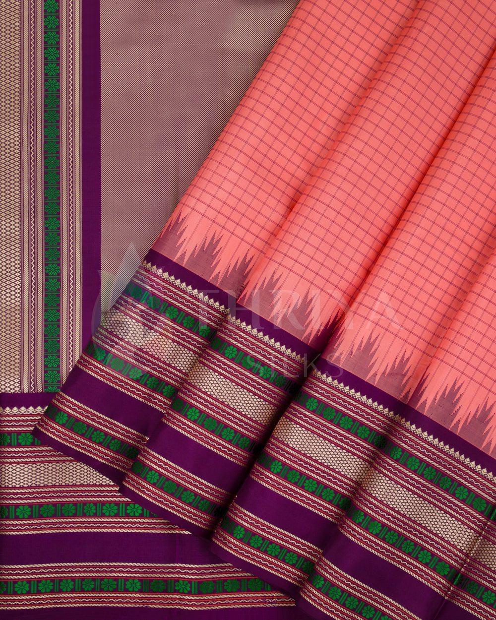 Peach Kanjivaram silk saree with purple border, green zari detailing, and temple-style pallu