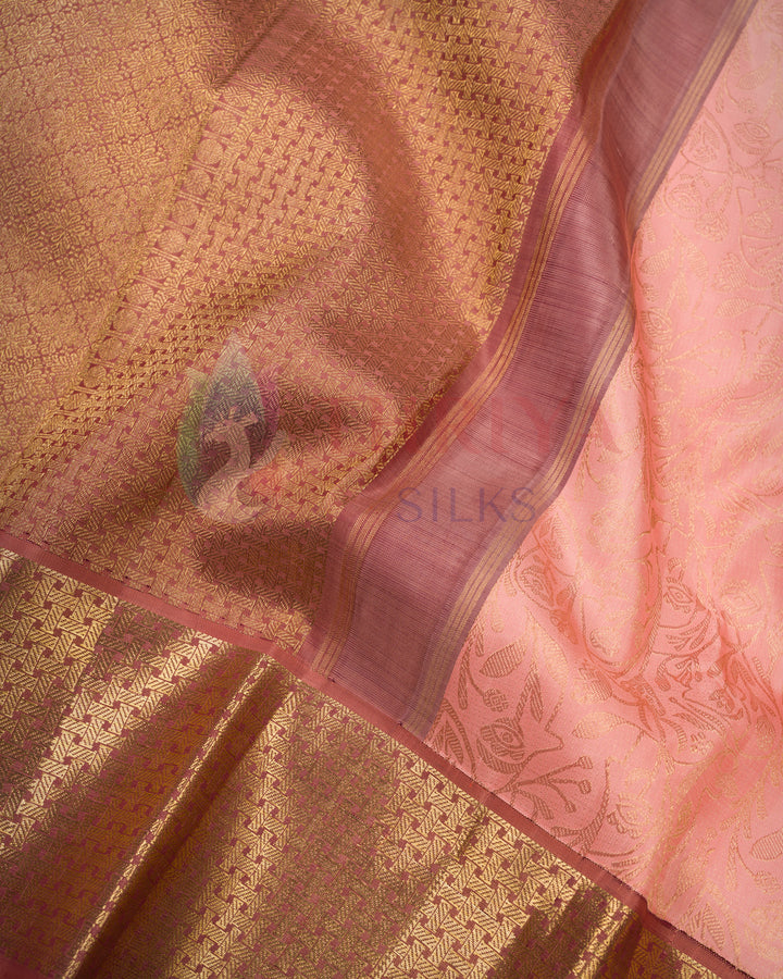Close-up draped view of peach pink Kanjivaram silk saree with rich copper zari pallu and traditional woven border – Thriya Silks 