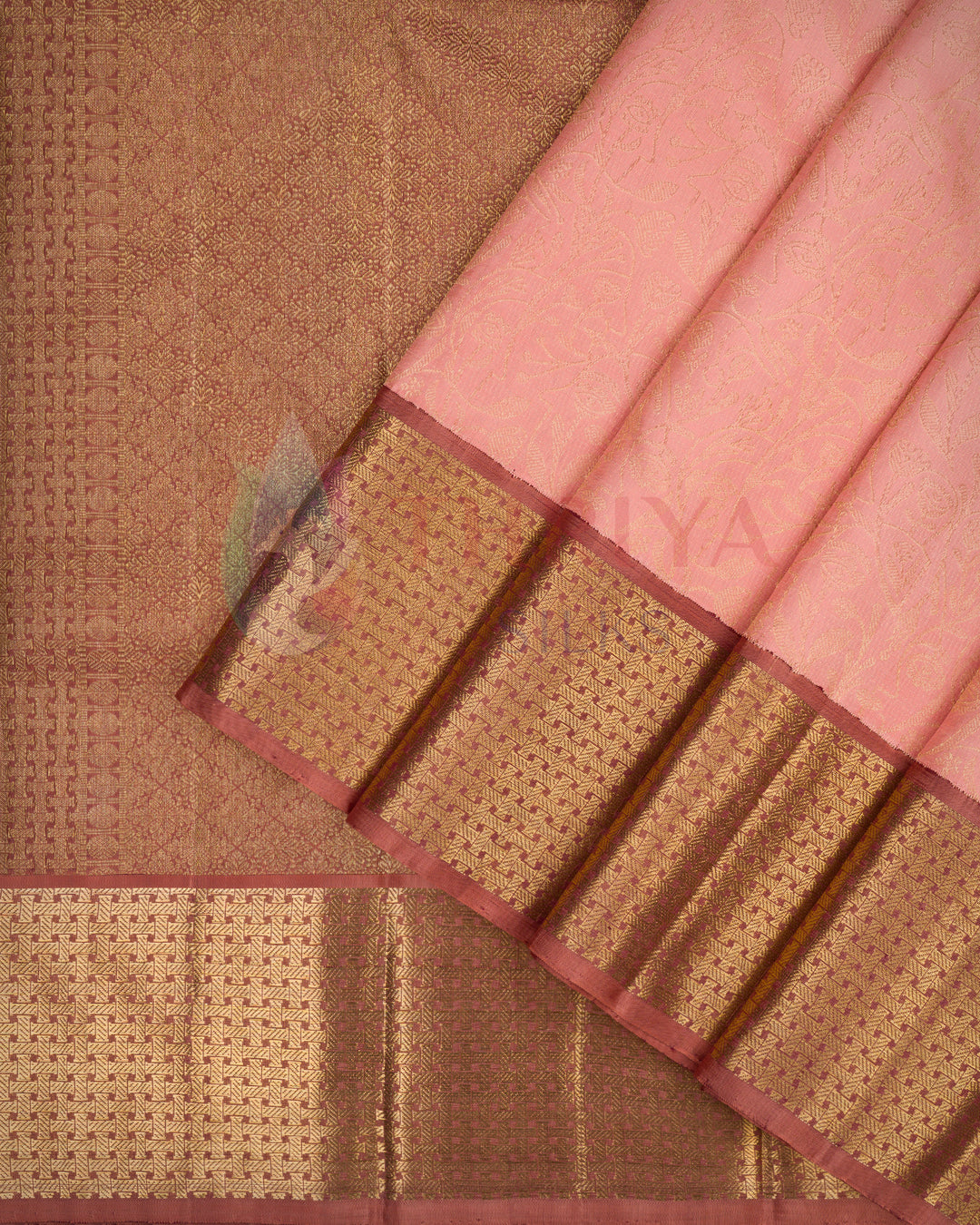 Folded view of peach pink Kanjivaram silk saree featuring a rich copper-gold zari border and intricately woven pallu – Thriya Silks